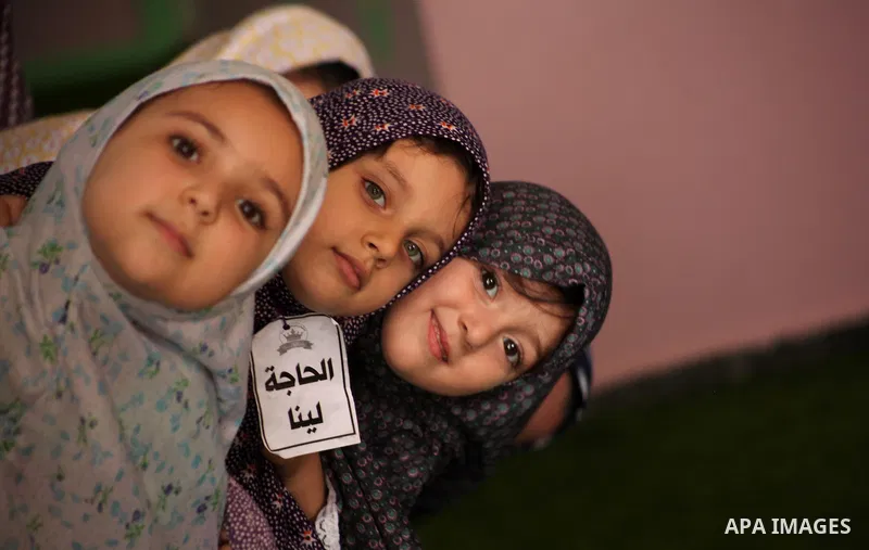 Palestinian children gather around a makeshift cube representing the holy Kaaba in Gaza city, on Sept. 21, 2015, as part of training children how to perform Hajj pilgrimage. Muslims from around the world flood Saudi city...