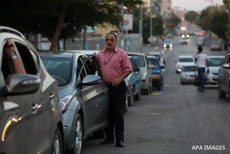 Palestinian drivers wait in line to fill their cars in front of a filling station in Gaza City, on September 21, 2015. Due to severe fuel shortages, the Gaza power plant has been operating at approximately half of its ca...