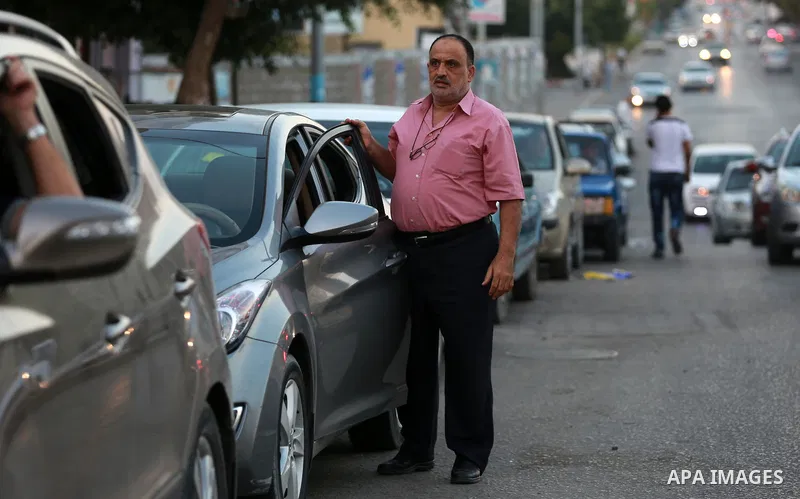 Palestinian drivers wait in line to fill their cars in front of a filling station in Gaza City, on September 21, 2015. Due to severe fuel shortages, the Gaza power plant has been operating at approximately half of its ca...