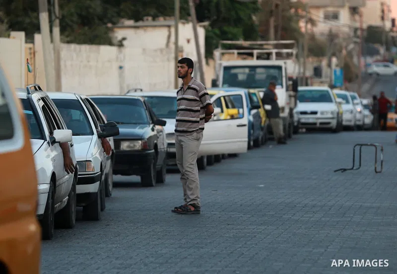 Palestinian drivers wait in line to fill their cars in front of a filling station in Gaza City, on September 21, 2015. Due to severe fuel shortages, the Gaza power plant has been operating at approximately half of its ca...