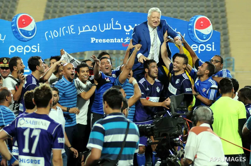 El-Zamalek Chairman Mortada Mansour and players celebrate with the trophy after winning their Egyptian Cup finals derby soccer match against Al-Ahly at Petro Sport stadium in Cairo, Egypt, September 21, 2015. Photo by St...