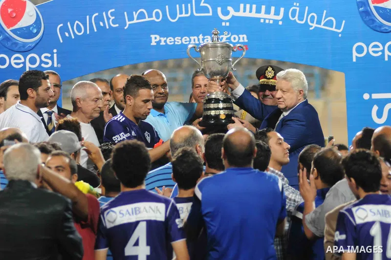El-Zamalek Chairman Mortada Mansour and players celebrate with the trophy after winning their Egyptian Cup finals derby soccer match against Al-Ahly at Petro Sport stadium in Cairo, Egypt, September 21, 2015. Photo by St...