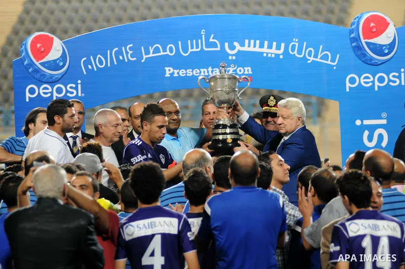 El-Zamalek Chairman Mortada Mansour and players celebrate with the trophy after winning their Egyptian Cup finals derby soccer match against Al-Ahly at Petro Sport stadium in Cairo, Egypt, September 21, 2015. Photo by St...