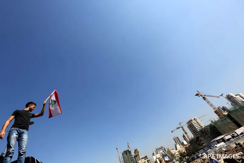 Lebanese anti-government protesters take part in a protest on a road leading to the parliament, where leading figures of Lebanon's main political parties meet for the third time in an effort to end the paralysis plaguing...