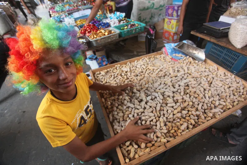 Palestinians shop in a market ahead of the major Muslim festival of Eid al-Adha holiday, in Khan Younis in the southern Gaza strip, on Sept. 23, 2015. Eid al-Adha, or Feast of Sacrifice, commemorates what Muslims believe...