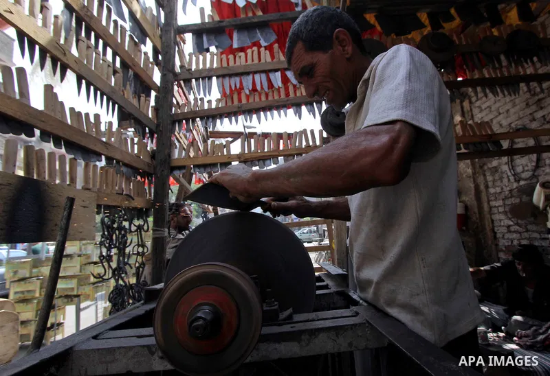 An Egyptian man sharpens a knife at a shop ahead of the sacrificial Eid al-Adha festival in Cairo on September 23, 2015. Muslims across the world are preparing to celebrate the annual festival of Eid al-Adha, or the Fest...