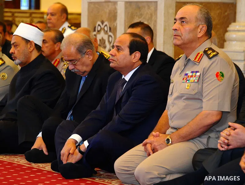 In this picture provided by the office of the Egyptian Presidency, Egyptian President Abdel-Fattah el-Sissi, center right, sits for Eid al-Adha prayers at the Field Marshal Hussein Tantawi Mosque in New Cairo, Egypt, Thu...