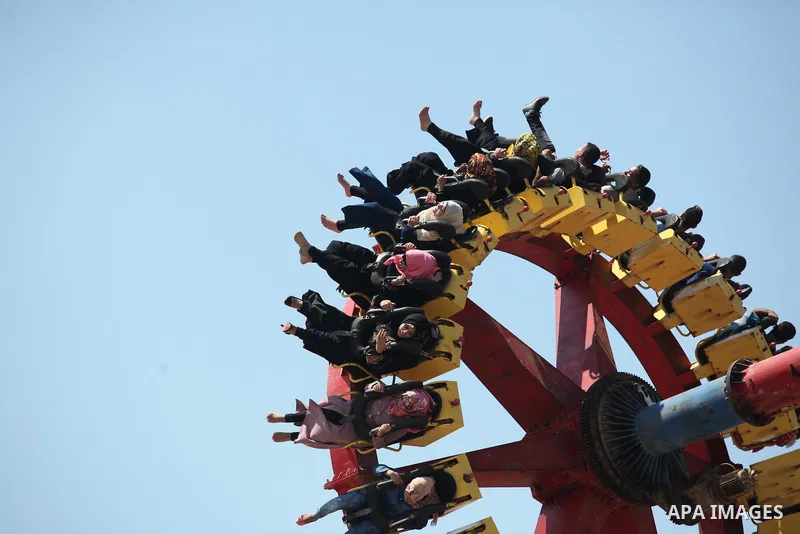 Palestinians play at an amusement park during the fourth day of Eid al-Adha or "Feast of the sacrifice" in Gaza City on September 27, 2015. Muslims across the world are celebrating the annual festival of Eid al-Adha whic...
