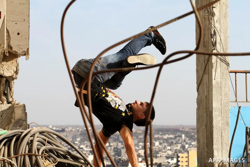 A member of Palestinian '3run Gaza' team, practices his parkour skills on a building in preparation for the "Gulf Monster", the first Arab parkour competition in Qatar in November 2015, in Gaza city on September 29, 2015...