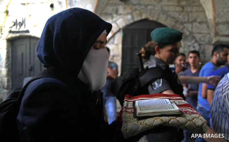 A Palestinian woman from the so-called Murabitat group, holds a copy of the holy Quran during a protest against Jewish groups visiting the Al-Aqsa mosque compound and against preventing them from entering the shrine on S...