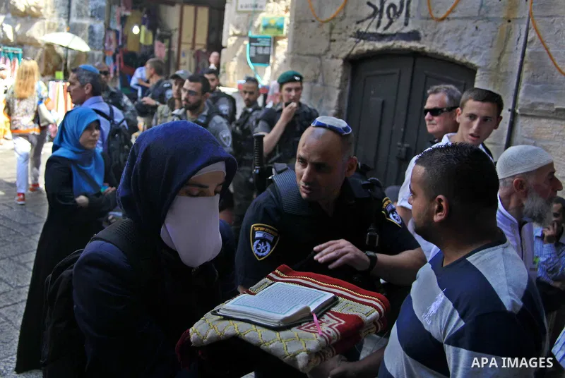 A Palestinian woman from the so-called Murabitat group, holds a copy of the holy Quran during a protest against Jewish groups visiting the Al-Aqsa mosque compound and against preventing them from entering the shrine on S...