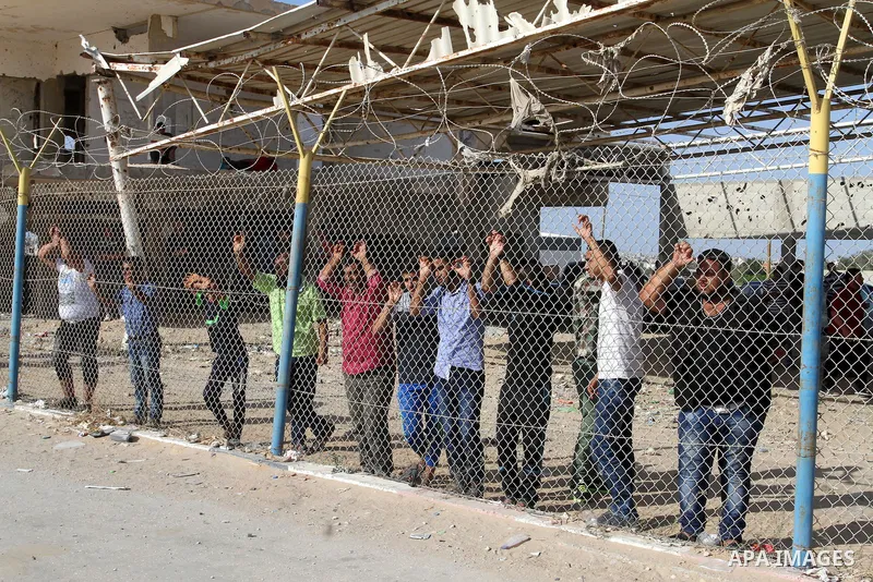 Palestinians wait for their pilgrim relatives at the Rafah crossing between Gaza Strip and Egypt after performing the annual Hajj, in Rafah in southern Gaza Strip, September 30, 2015. Around 500 Hajj pilgrims cross Rafah...