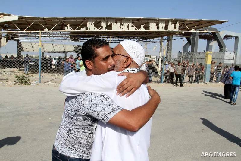 A Palestinian man welcomes his pilgrim relative at the Rafah crossing between Gaza Strip and Egypt after performing the annual Hajj, in Rafah in southern Gaza Strip, September 30, 2015. Around 500 Hajj pilgrims cross Raf...