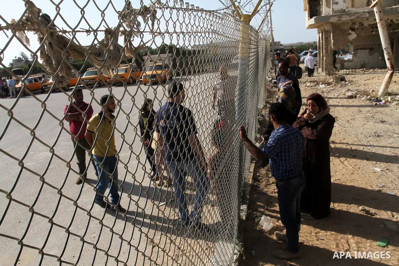 Palestinians wait for their pilgrim relatives at the Rafah crossing between Gaza Strip and Egypt after performing the annual Hajj, in Rafah in southern Gaza Strip, September 30, 2015. Around 500 Hajj pilgrims cross Rafah...