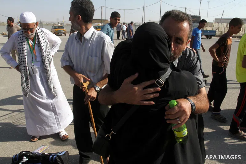 A Palestinian man welcomes his pilgrim relative at the Rafah crossing between Gaza Strip and Egypt after performing the annual Hajj, in Rafah in southern Gaza Strip, September 30, 2015. Around 500 Hajj pilgrims cross Raf...