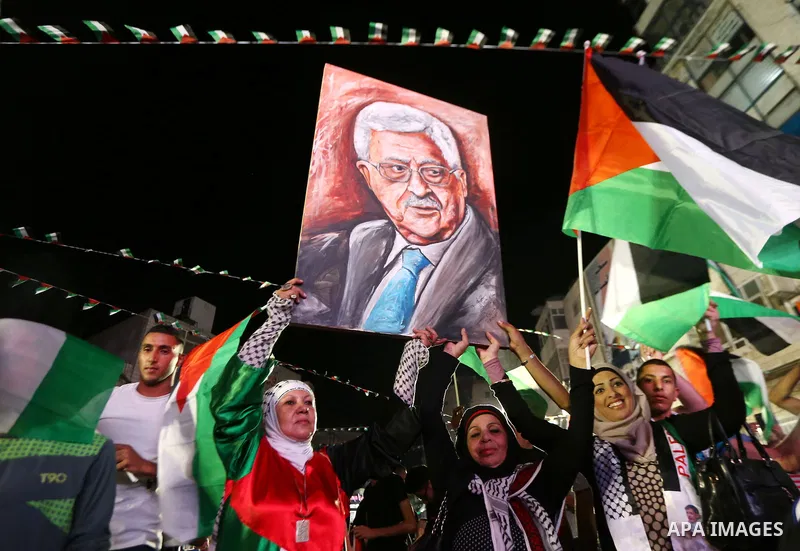Palestinians celebrate following the Palestinian President Mahmoud Abbas' speech at the General Assembly at the United Nations, in the West Bank city of Ramallah on September 30, 2015. Demonstrating a new level of tensio...