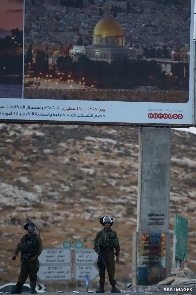 Israeli security forces take position during clashes with Palestinian protesters over the Al-Aqsa mosque compound, close to the Israeli manned checkpoint of Hezma in the Israeli occupied West Bank, between Jerusalem and...