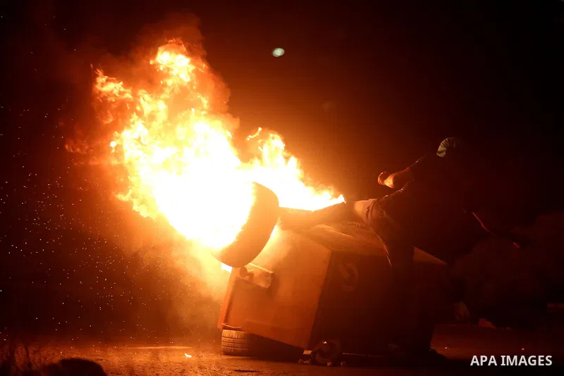 A Palestinian protester burns tyres during clashes with Israeli soldiers close to the Jewish settlement of Bet El, in the West Bank city of Ramallah on October 4, 2015 after Israel barred Palestinians from Jerusalem's Ol...