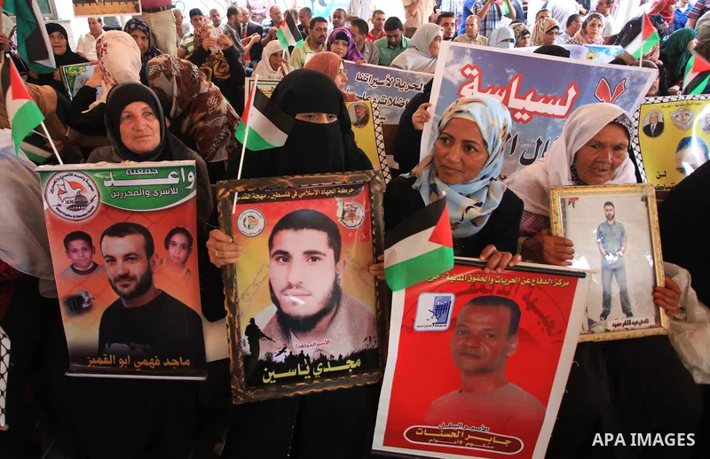 Relatives of Palestinian prisoners in Israeli jails, take part in a protest to show solidarity with Palestinians clashing with Israeli security forces at Jerusalem's al-Aqsa mosque, outside the Red Cross office, in Gaza...
