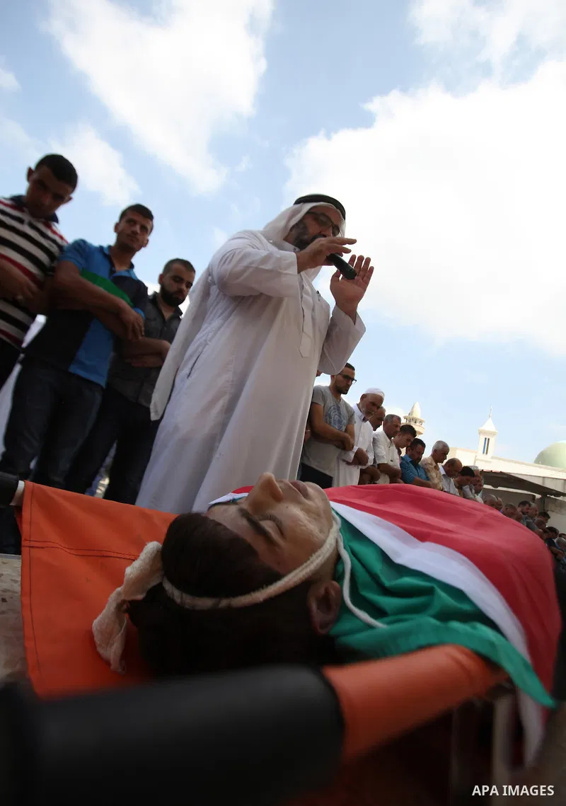 Palestinian mourners pray over the body of Huzaifah Sulaiman during his funeral in Balaa village near the West Bank city of Tulkarem, October 5, 2015. Tensions have been further inflamed by frequent clashes between Pales...