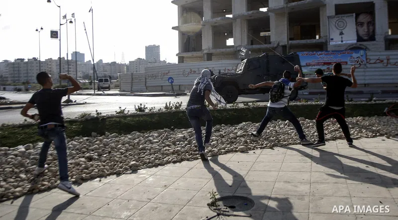 Palestinian protesters throw stones towards Israeli troops during clashes near the Jewish settlement of Bet El, near the occupied West Bank city of Ramallah October 5, 2015. Violence intensified in Jerusalem and the West...
