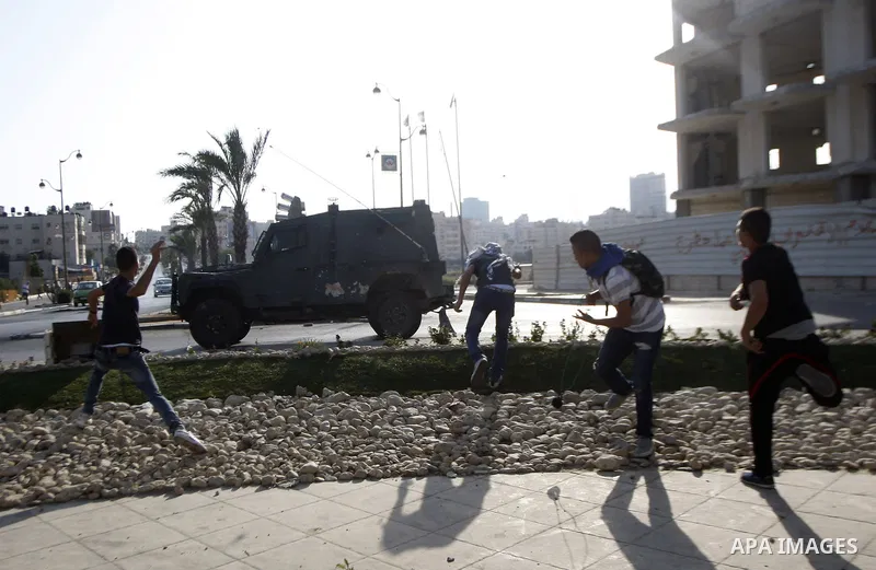Palestinian protesters throw stones towards Israeli troops during clashes near the Jewish settlement of Bet El, near the occupied West Bank city of Ramallah October 5, 2015. Violence intensified in Jerusalem and the West...