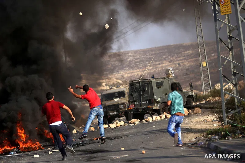 Palestinian protesters throw stones towards Israeli troops during clashes near the Jewish settlement of Bet El, near the occupied West Bank city of Ramallah October 5, 2015. Violence intensified in Jerusalem and the West...