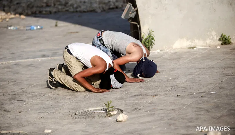 Palestinian protesters pray during clashes with Israeli troops near the Jewish settlement of Bet El, near the occupied West Bank city of Ramallah October 5, 2015. Violence intensified in Jerusalem and the West Bank on Su...