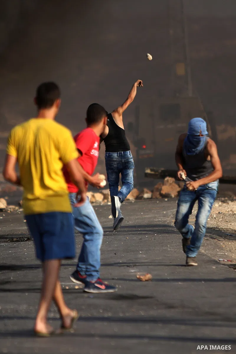 Palestinian protesters throw stones towards Israeli troops during clashes near the Jewish settlement of Bet El, near the occupied West Bank city of Ramallah October 5, 2015. Violence intensified in Jerusalem and the West...