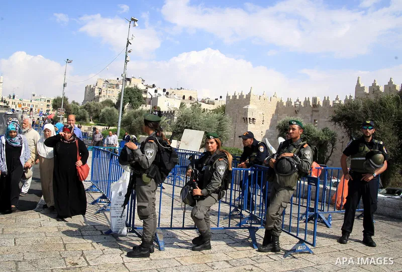 Israeli policemen stand guard as Palestinians enter the al-Aqsa mosque compound in Jerusalem's old city Friday, Oct. 9, 2015. At least four attacks, three by Palestinians and one by an Israeli, as well as deadly clashes...
