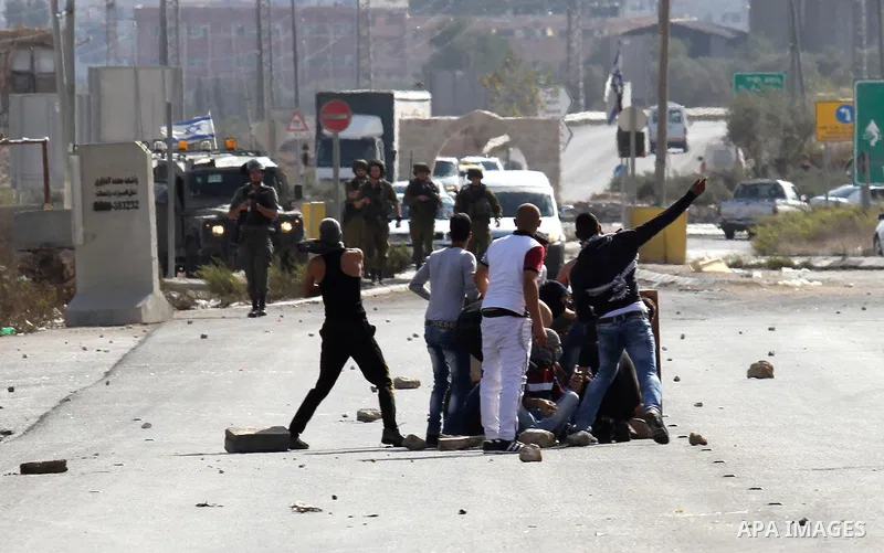 Palestinian protesters throw stones towards Israeli security forces during clashes at the Howara checkpoint near the West Bank city of Nablus, October 9, 2015. Tension and protests rose after an Israeli man on 09 October...
