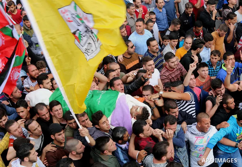 Mourners carry the body of Palestinian Mohammed Jabari, who stabbed an Israeli policeman before being shot dead on Friday, in the West Bank city of Hebron October 10, 2015. Fifteen Palestinians have been killed by Israel...