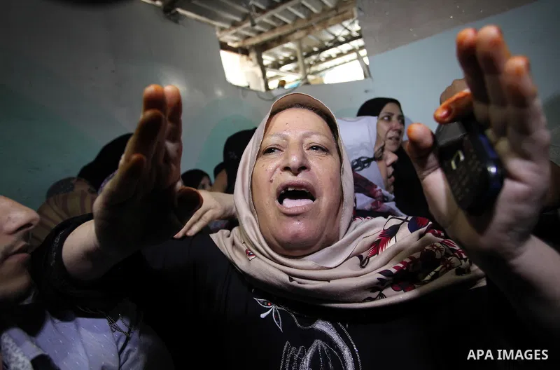 Relatives of two-year-old Palestinian girl Rahaf, mourn during the funeral of the toddler and her pregnant mother on October 11, 2015, at the al-Nusairat refugee camp, in central Gaza Strip. A pregnant Palestinian mother...