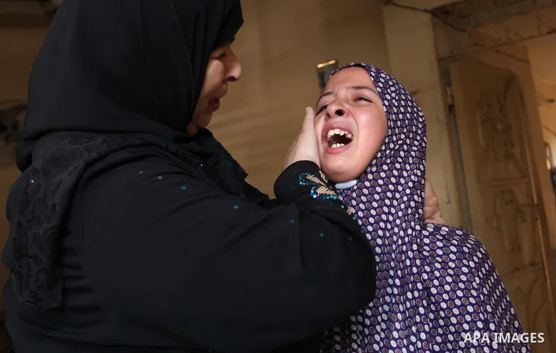 Relatives of two-year-old Palestinian girl Rahaf, mourn during the funeral of the toddler and her pregnant mother on October 11, 2015, at the al-Nusairat refugee camp, in central Gaza Strip. A pregnant Palestinian mother...
