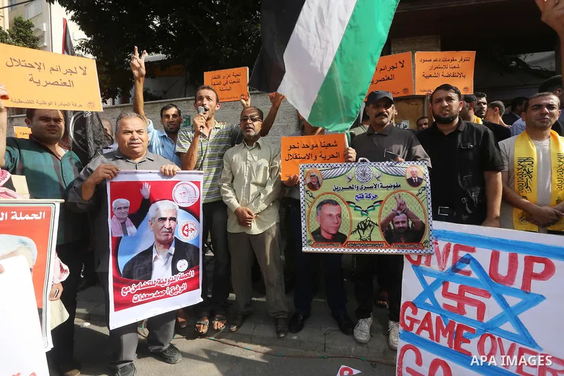 Palestinians take part in a protest in solidarity with Palestinians in the West Bank and against Jewish groups visiting the al-Aqsa mosque compound, in Gaza city on October 12, 2015. Photo by Mohammed Asad