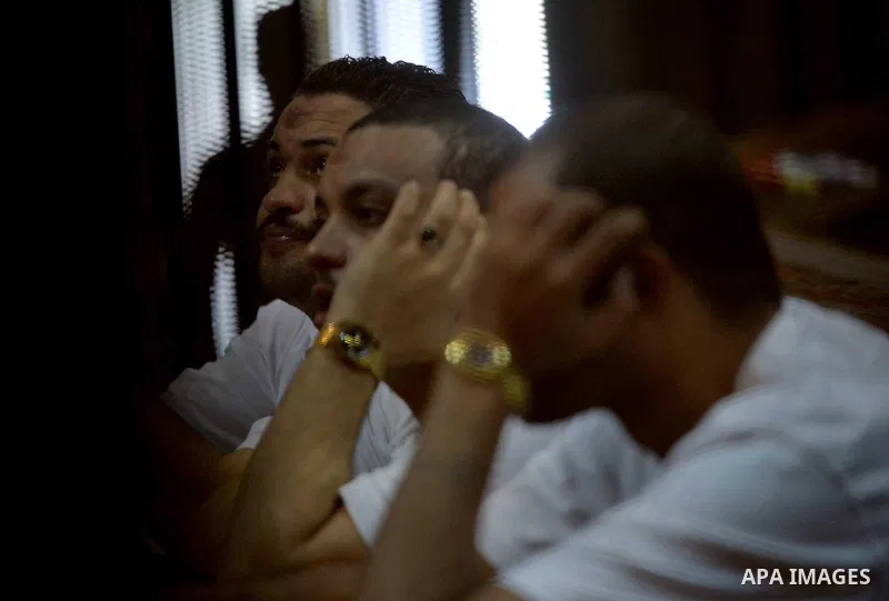 Egyptian defendants wait behind bars for the verdict in their retrial over a 2012 stadium riot in the canal city of Port Said at the police academy on the outskirts of the capital Cairo on Oct. 12, 2015. Seven defendants...