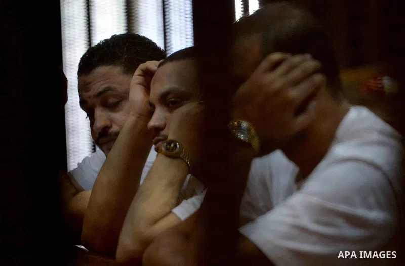 Egyptian defendants wait behind bars for the verdict in their retrial over a 2012 stadium riot in the canal city of Port Said at the police academy on the outskirts of the capital Cairo on Oct. 12, 2015. Seven defendants...