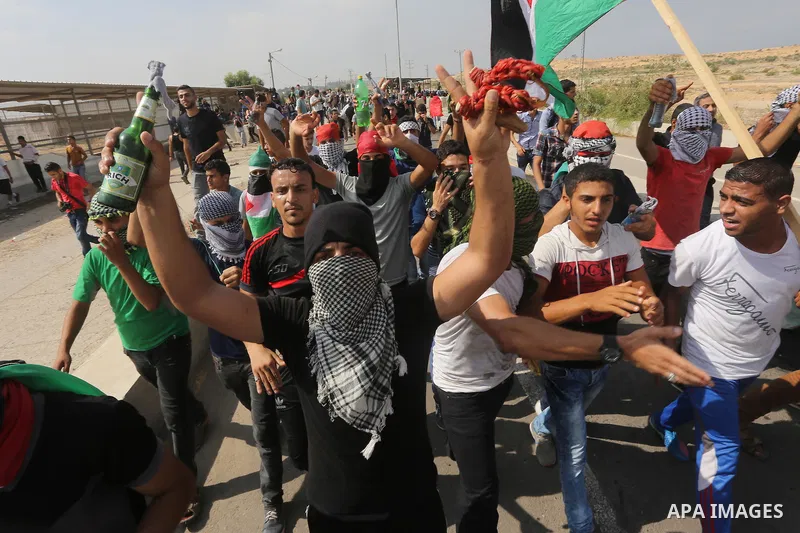 Palestinians gather during clashes with Israeli security forces near the Erez border crossing between Israel and northern Gaza Strip on October 13, 2015. A wave of stabbings that hit Israel, Jerusalem and the West Bank t...