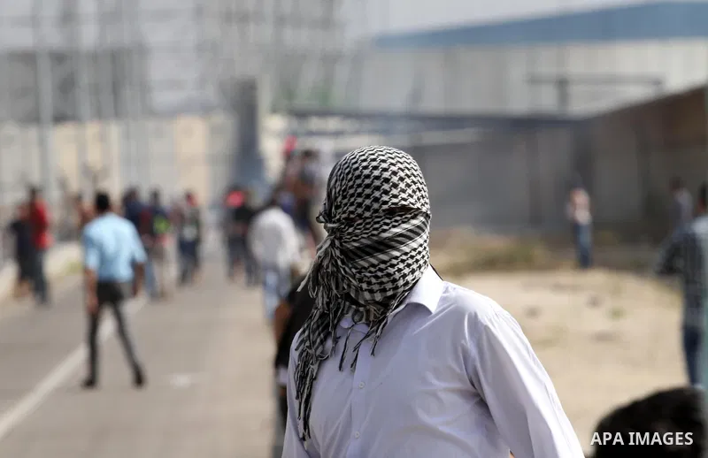 Palestinians gather during clashes with Israeli security forces near the Erez border crossing between Israel and northern Gaza Strip on October 13, 2015. A wave of stabbings that hit Israel, Jerusalem and the West Bank t...