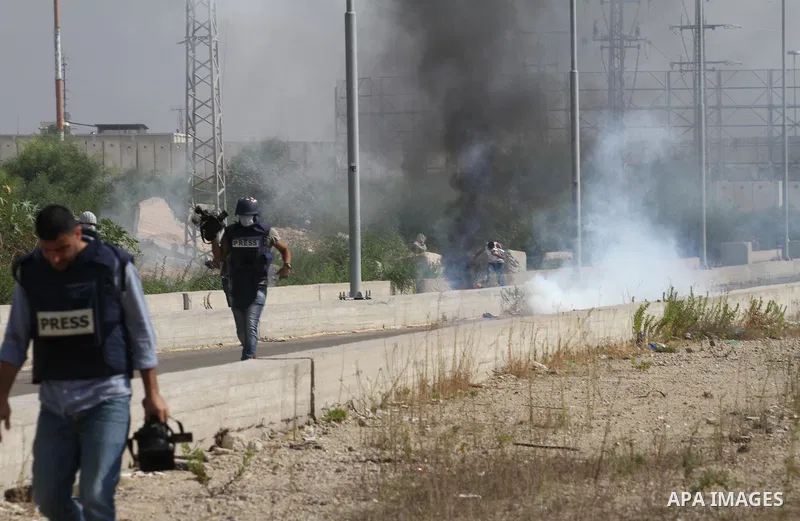 Palestinians gather during clashes with Israeli security forces near the Erez border crossing between Israel and northern Gaza Strip on October 13, 2015. A wave of stabbings that hit Israel, Jerusalem and the West Bank t...