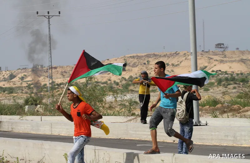 Palestinians gather during clashes with Israeli security forces near the Erez border crossing between Israel and northern Gaza Strip on October 13, 2015. A wave of stabbings that hit Israel, Jerusalem and the West Bank t...