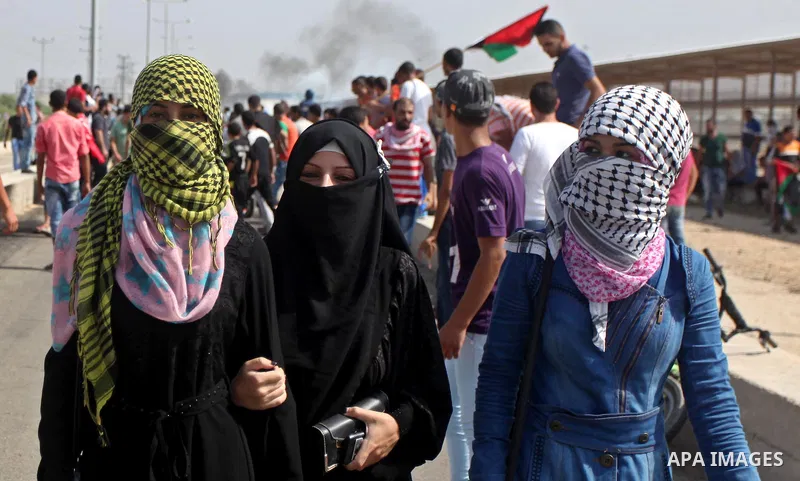 Palestinian girls gather during clashes with Israeli security forces next to the border fence with Israel, at the Erez crossing in the northern Gaza strip, on October 13, 2015. A wave of stabbings that hit Israel, Jerusa...