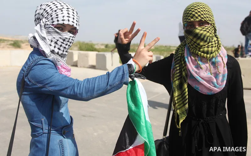 Palestinian girls flash victory sign during clashes with Israeli security forces next to the border fence with Israel, at the Erez crossing in the northern Gaza strip, on October 13, 2015. A wave of stabbings that hit Is...