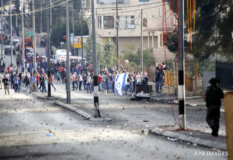 Palestinian protesters throw stones at Israeli security forces during clashes in the West Bank city of Bethlehem, on October 13, 2015. A wave of stabbings that hit Israel, Jerusalem and the West Bank this month along wit...