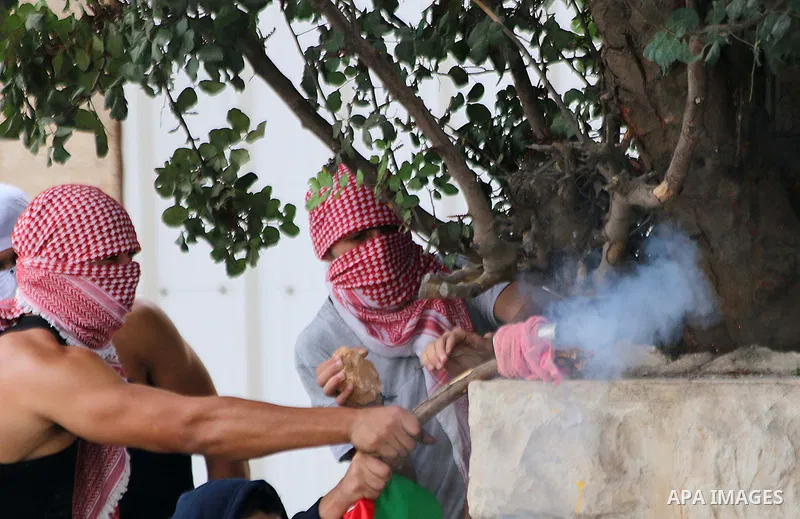 Palestinian protesters shoot fire crackers at Israeli security forces during clashes in the West Bank city of Bethlehem, on October 13, 2015. A wave of stabbings that hit Israel, Jerusalem and the West Bank this month al...