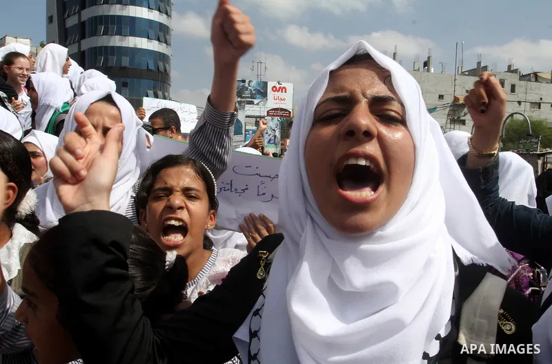Palestinian schoolgirls shout slogans during an anti-Israel protest in the southern Gaza Strip town of Rafah on October 14, 2015. Amid violent protests and a wave of stabbings spreading fear in Israel and warnings that a...