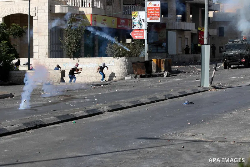 Palestinian protesters throw stones at Israeli troops during clashes in the West Bank city of Bethlehem October 14, 2015. Seven Israelis and 30 Palestinians, including children and assailants, have been killed in two wee...