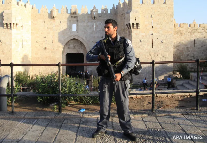 An Israeli policeman stands guard at the scene of killed of a man who attempted to carry out a knife attack at the Damascus Gate at the entrance of the Old City in east Jerusalem on October 14, 2015. Israeli police said...