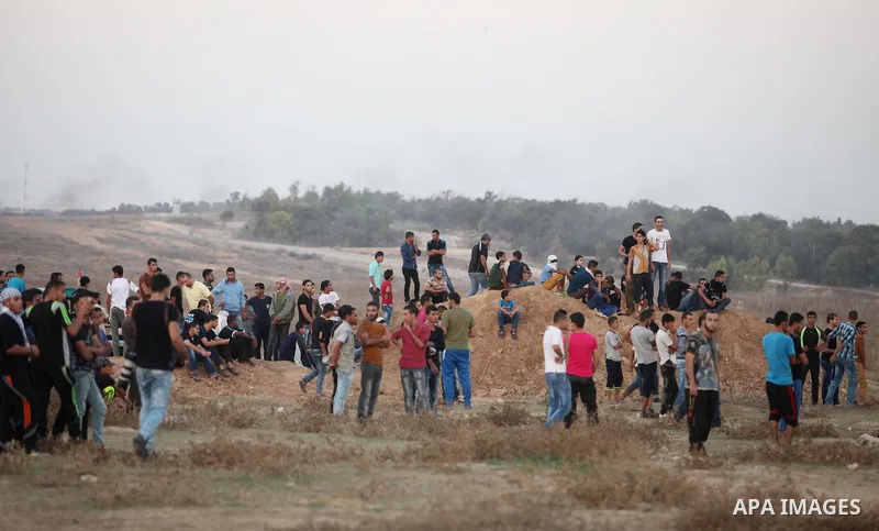 Palestinian protesters gather during clashes with Israeli troops near a border fence between Israel and the Gaza Strip on October 14, 2015 east of Bureij in central Gaza. The outbreak of violence between Palestinians and...