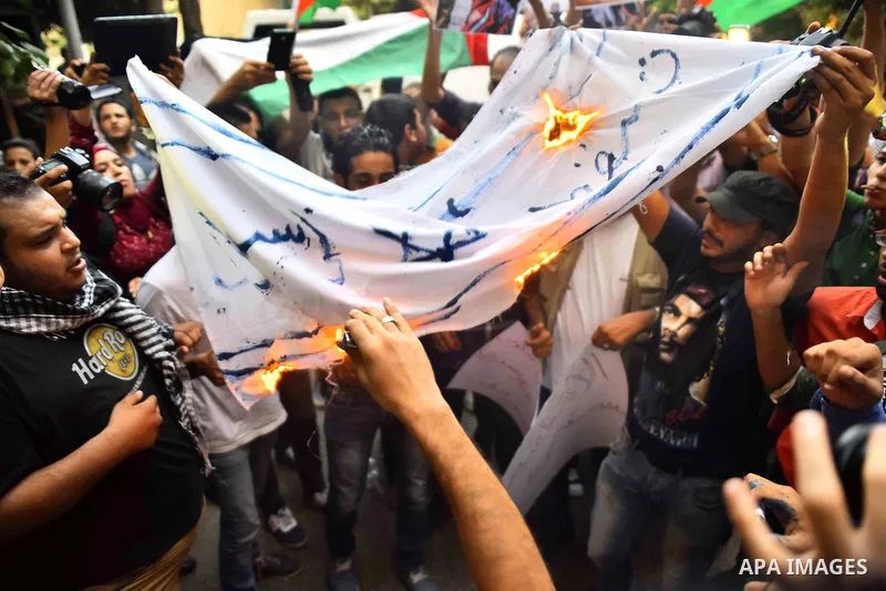Egyptian protesters burn a mock Israeli flag during a demonstration expressing solidarity with Palestinians, outside the Palestinian Embassy in Cairo, October 16, 2015. According to local reports a group of protesters ex...